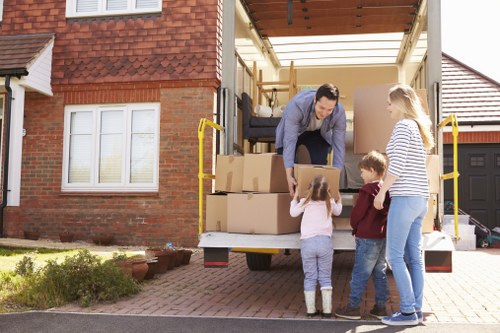 Removal team loading household items into a moving vehicle