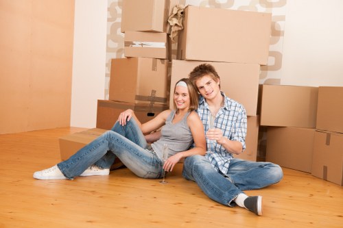 Packing materials and neatly labeled moving boxes for a home move in Woking