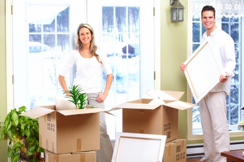 Professional movers handling household furniture during a Woking relocation