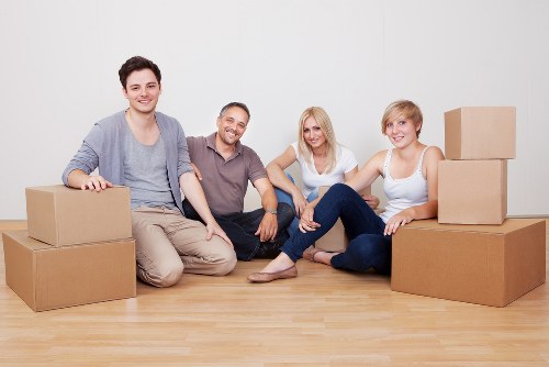 Mover carrying a furniture item through a doorway